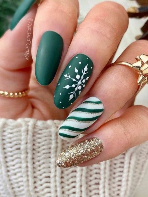 green and gold nails with stripes and snowflakes 
