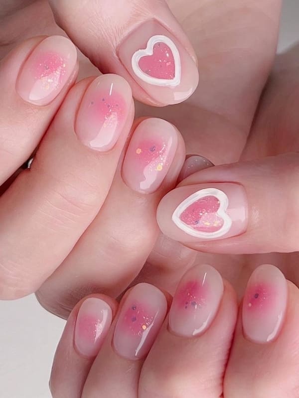 pink blush nails with 3D heart accents