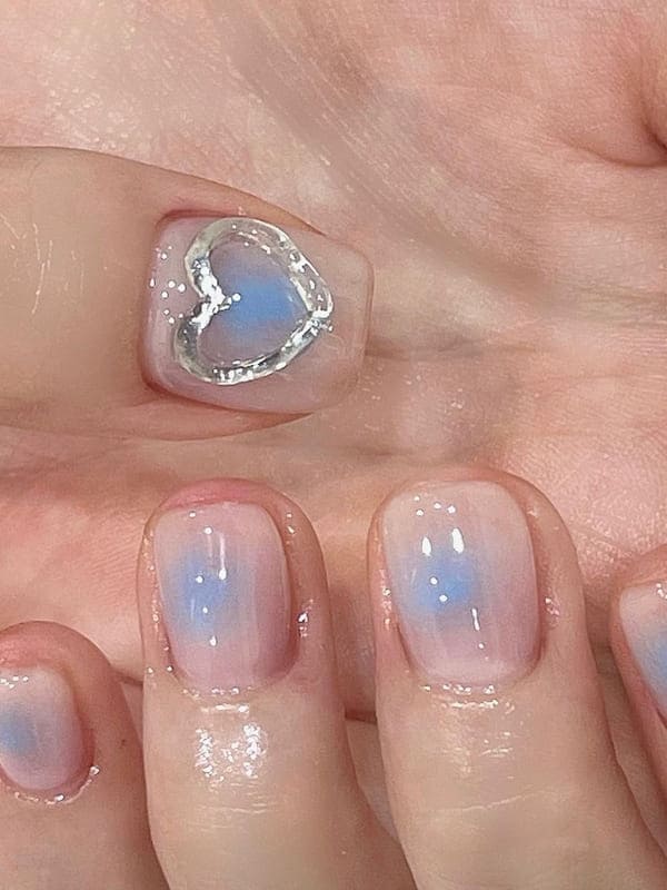 light blue cheek nails with heart accents