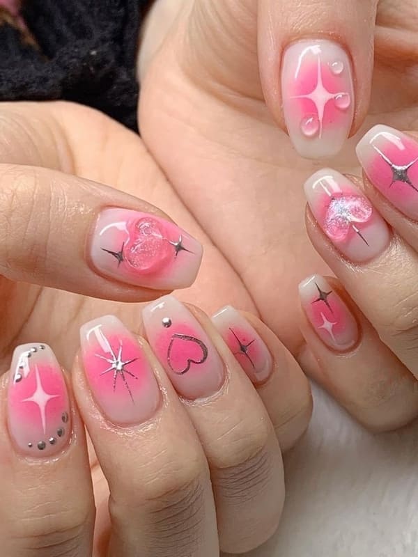 pink blush nails with 3D heart accents