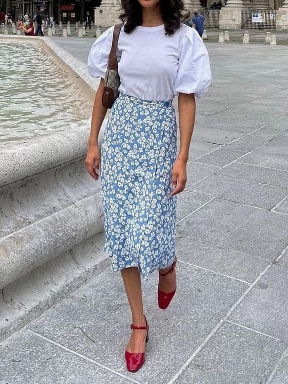 white top and light blue skirt with red sandal