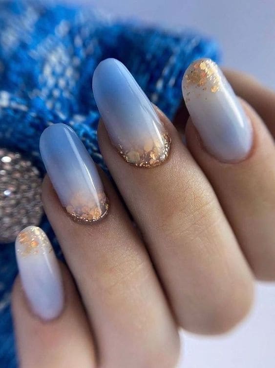blue manicure with gold glitter
