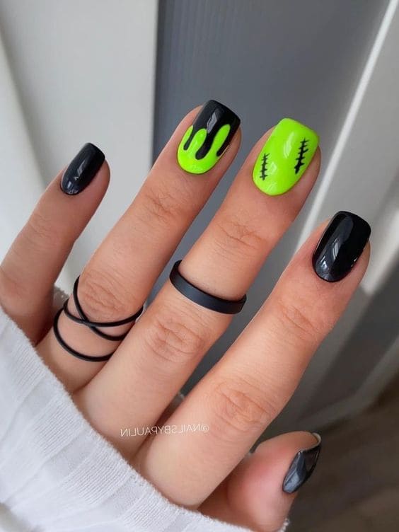 halloween acrylic nails in neon green and black