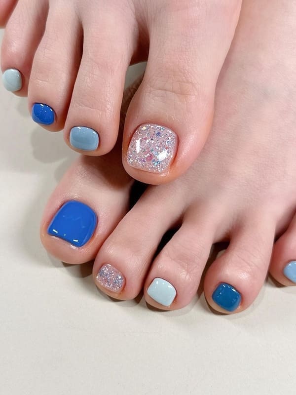 various blue and glitter toenails