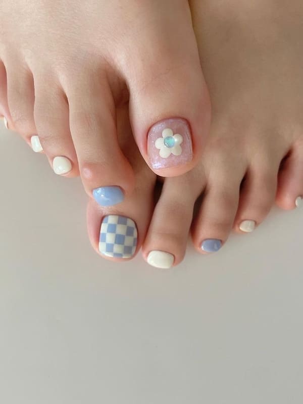 white and light blue toenails with a flower