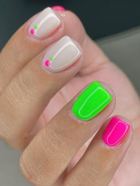 neon green and hot pink short nails with dot accents 
