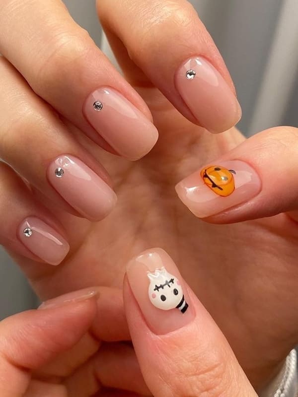 chic nude nails with Halloween accents