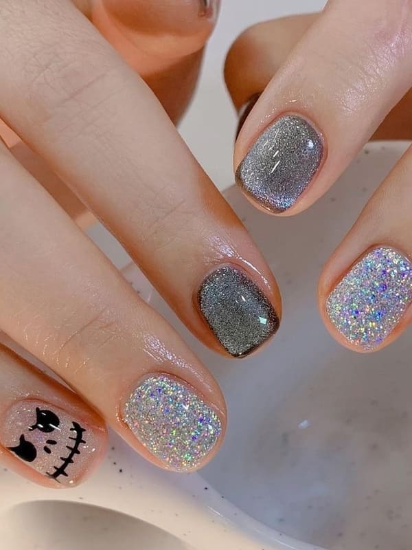 silver glitter nails with skeleton face