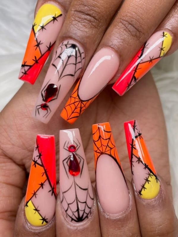 orange nails with spider webs 
