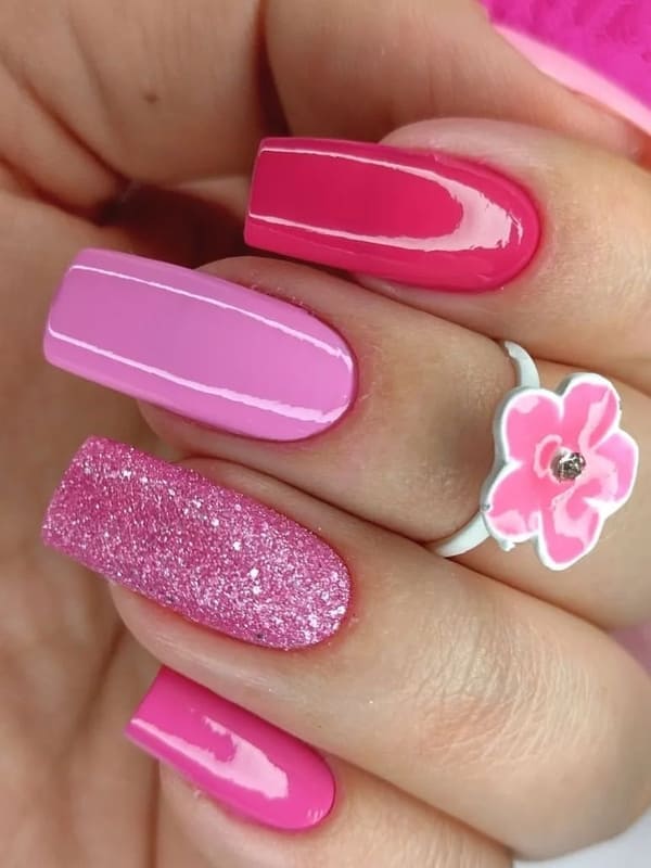 various pink colored nails with glitter