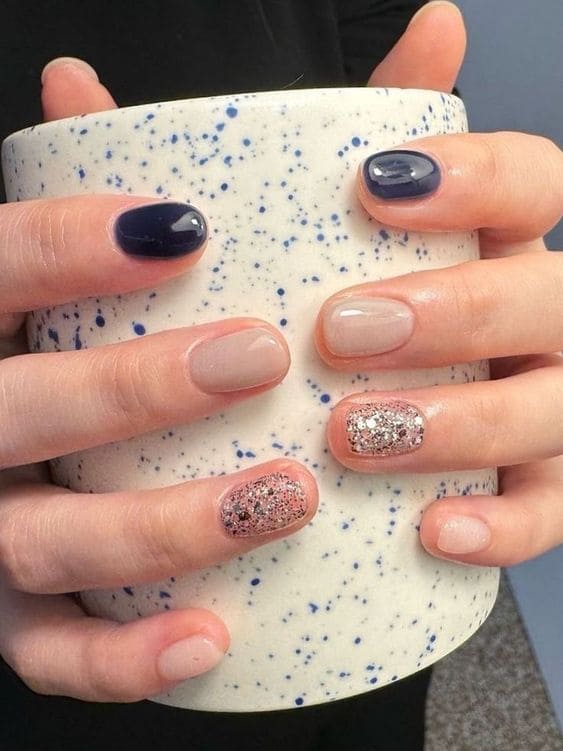 navy nails with glitter accent 