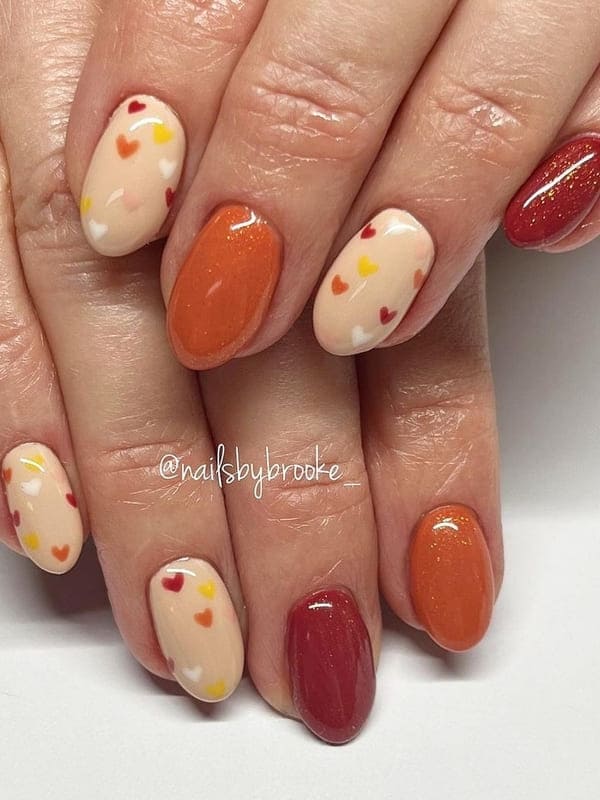 burnt orange nails with cute hearts