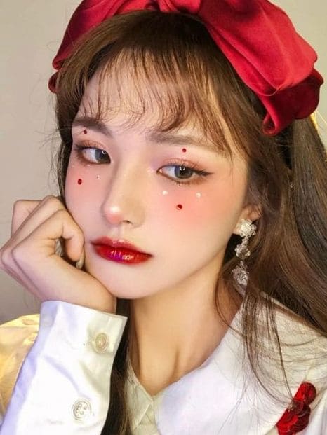 Korean Christmas makeup look: red gem accent 