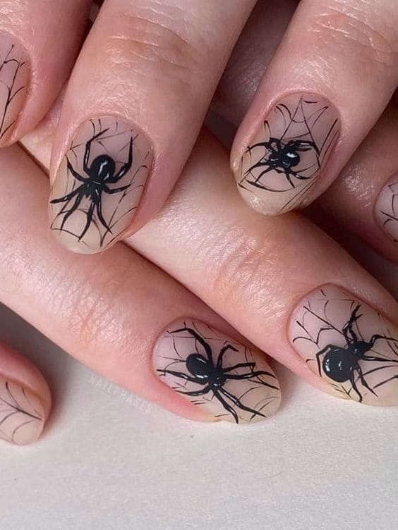 classy nude nails with spiders