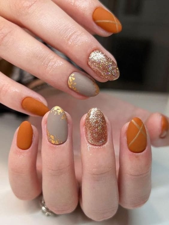 burnt orange nails with gold glitter