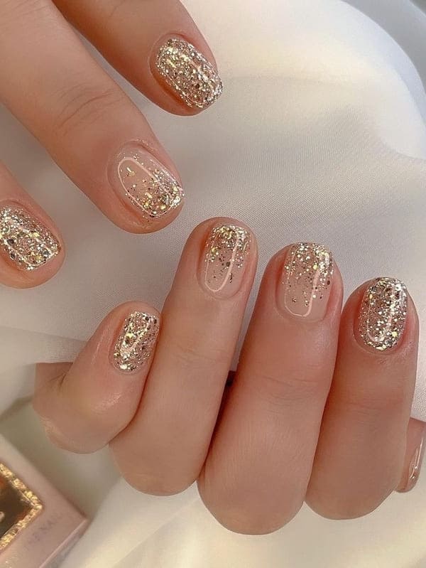 classy gold nails: glitter ombre