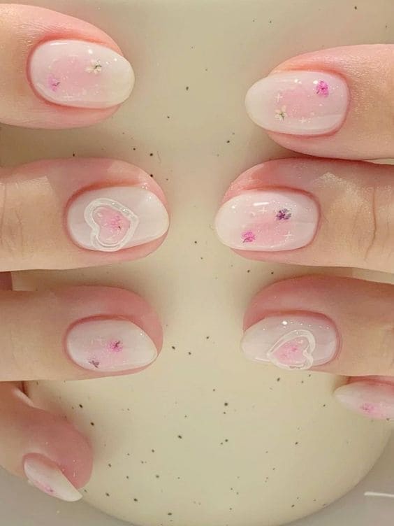 glittery pink blush nails with heart rings