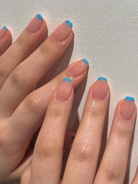 light blue nails: French tips