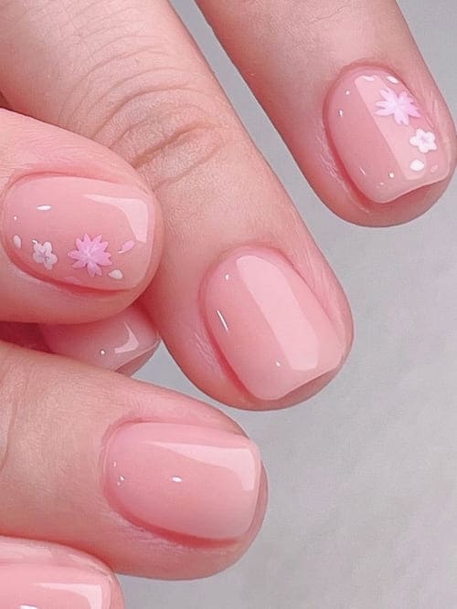 simple flower nail designs: nude base with tiny accent
