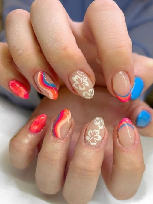 tropical nail design: red and blue swirls  