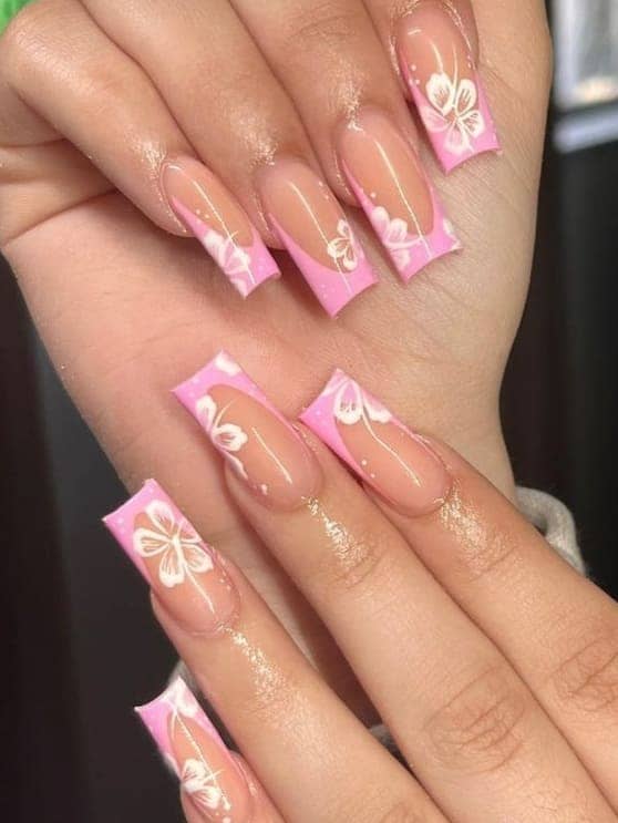 beach nail design: pink French tips with flowers
