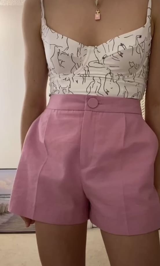 cute summer outfit: graphic corset top and pink shorts 