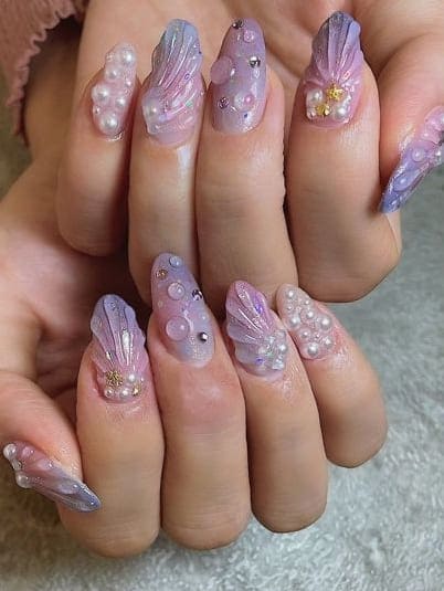 mermaid nail design: shimmery purple seashells 
