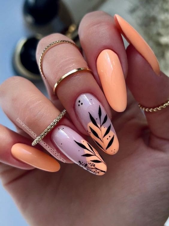 peach nail design: black leaves