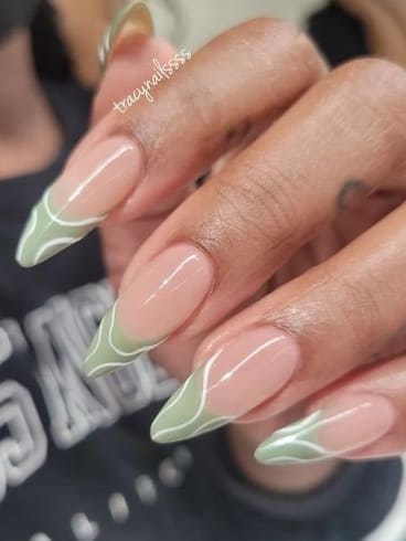 sage green nails: French tips with swirls 