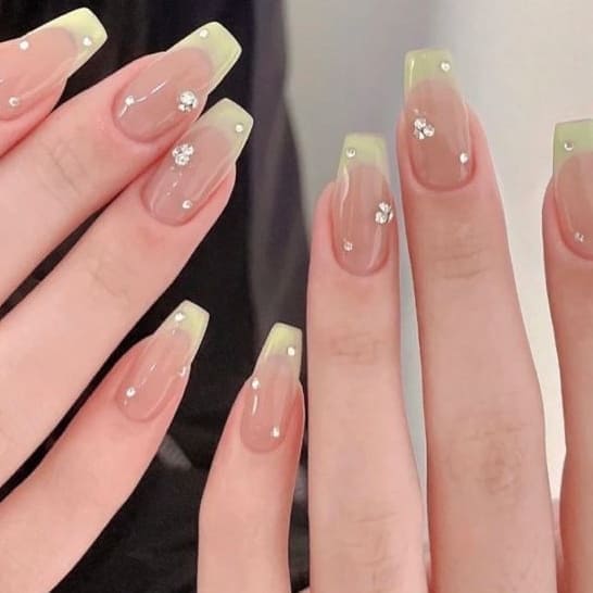 sage green nails: French tips with gems