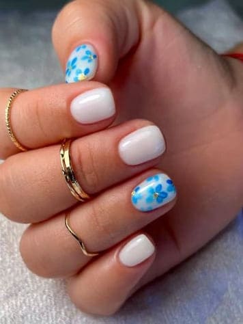 short summer nails: milky white nails with blue flowers 