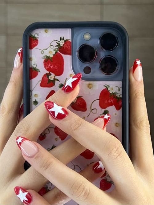 star nail design: red nails with white stars 